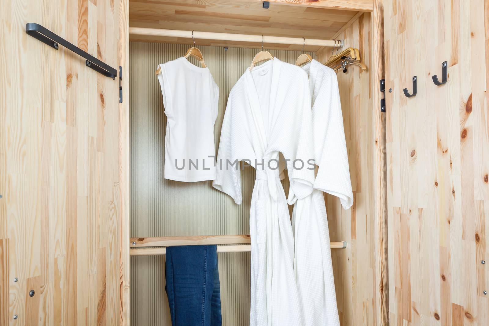 bathrobe and shirt, pants in wooden wardrobe