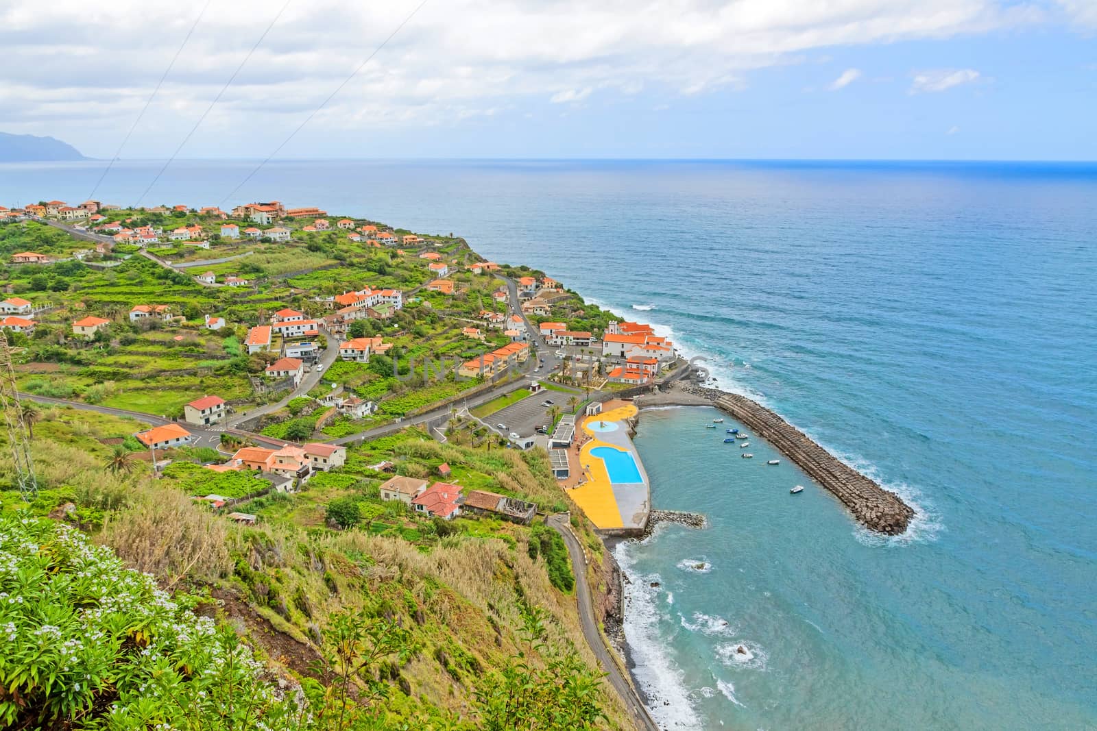 Ponta Delgada, Madeira - June 7, 2013: Eastern part of the village stretching into Atlantic Ocean - swimming bath in the foreground.