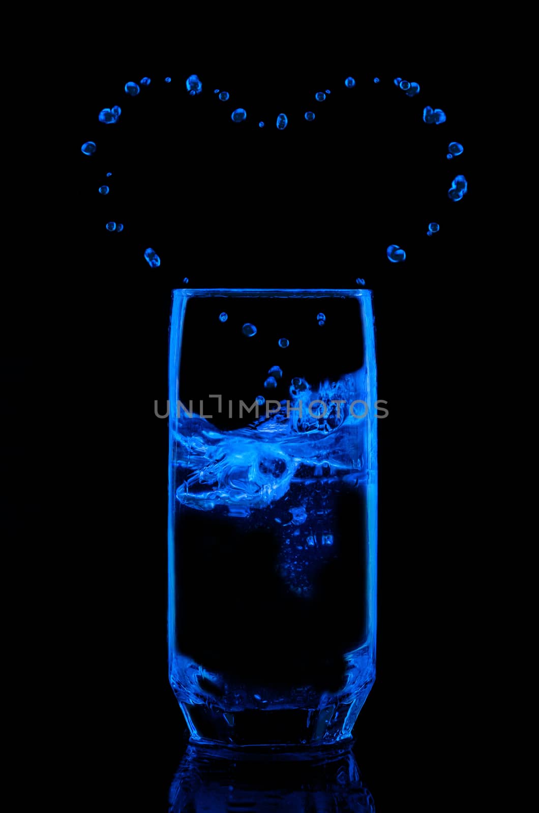 Water in a glass on black background by Gaina