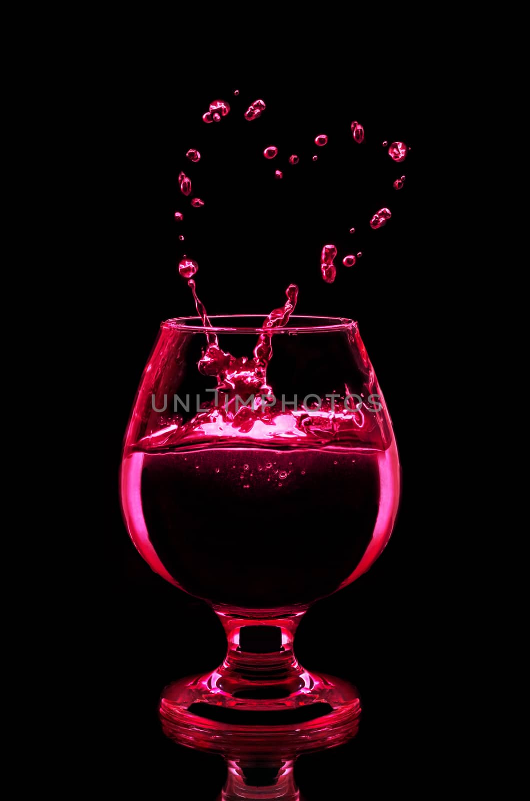 Cocktail in glass on black background by Gaina