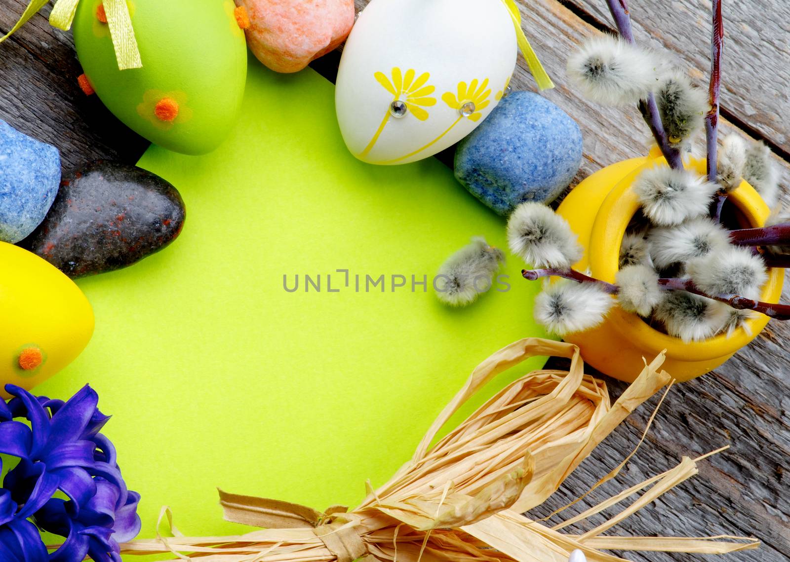 Easter Greeting Card with Pussy-Willow, Colored Stones, Crocus, Easter Eggs and Empty Green Place to Congratulations closeup on Wooden background