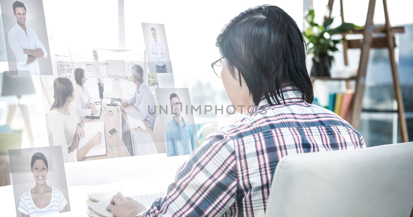 Business people having a meeting  against rear view of businessman using computer 