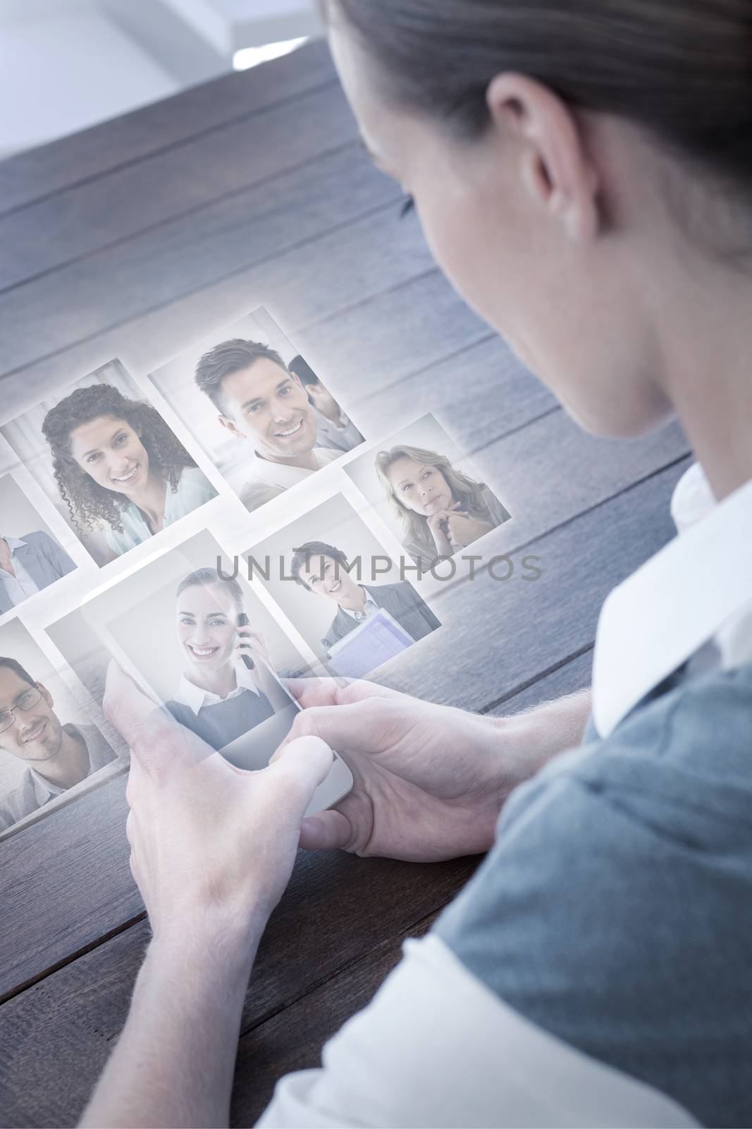 Portrait of business people  against close up view of businesswoman using her smartphone