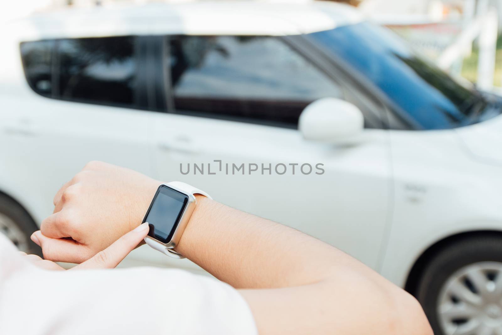 female hand touching on smartwatch by blackzheep
