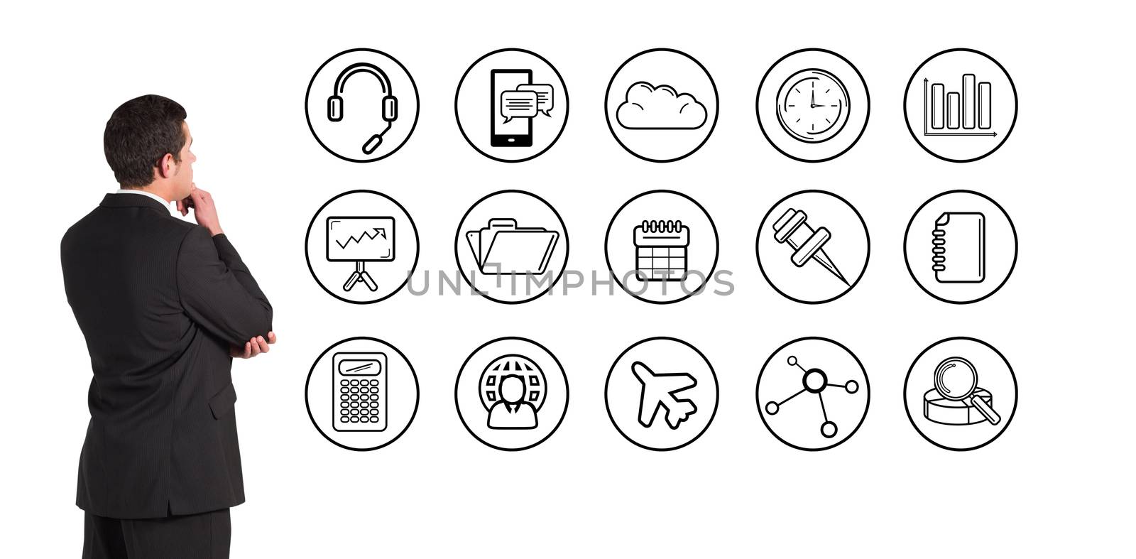 Businessman standing and looking against telephone apps icons 