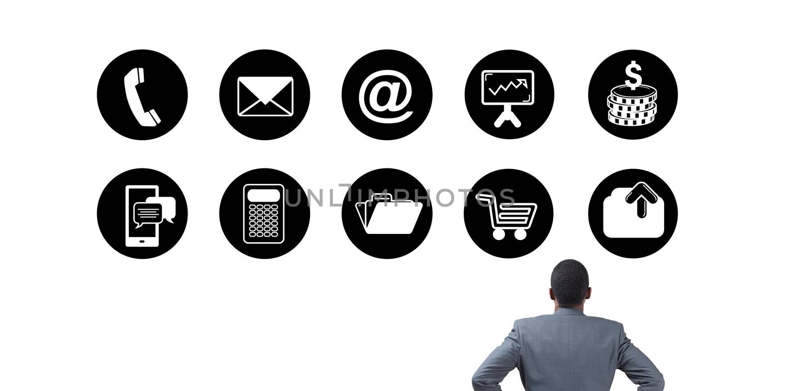 Businessman standing with hands on hips against telephone apps icons 