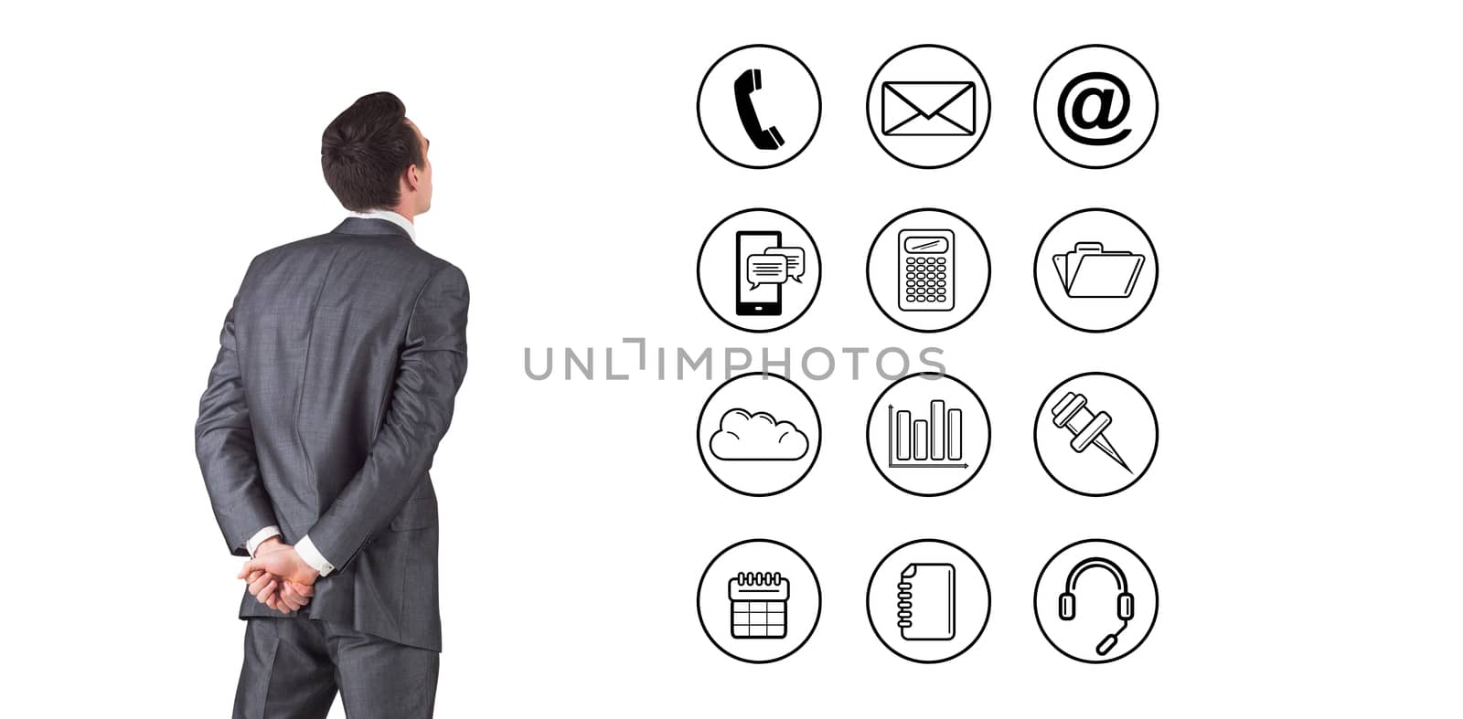 Businessman in grey suit looking against telephone apps icons 