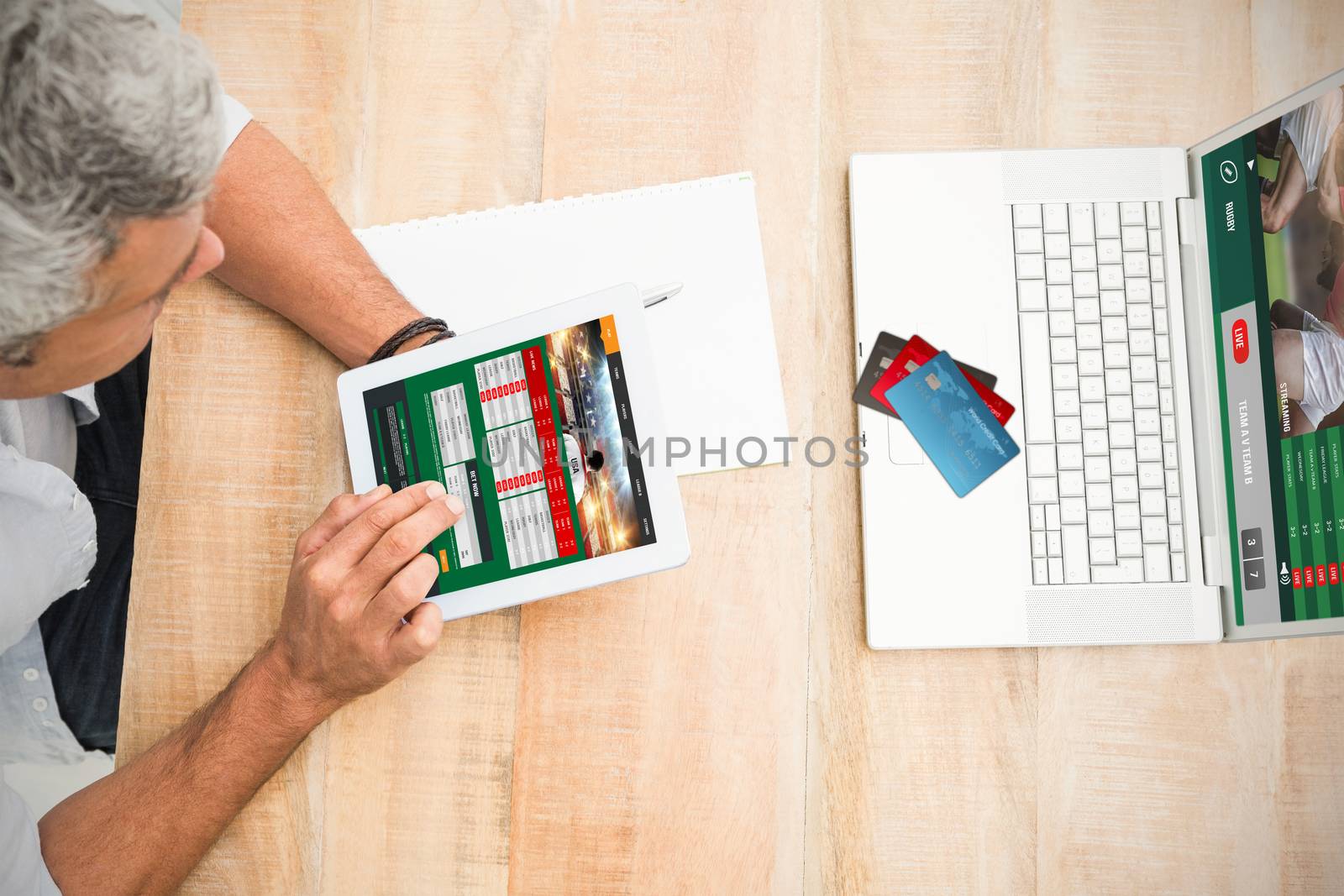 Colorful world credit cards against casual businessman using blank screen tablet