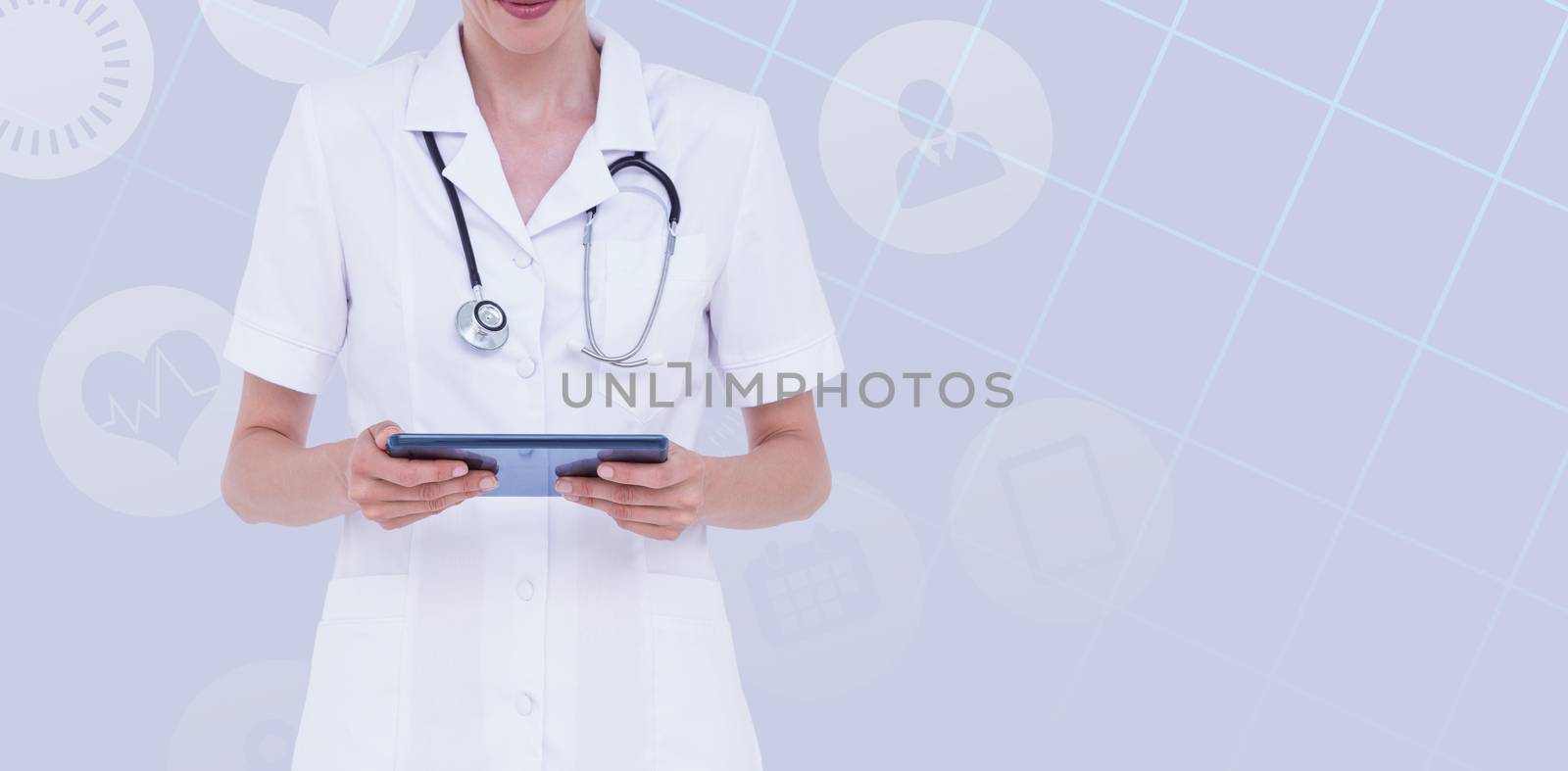 Midsection of female doctor using tablet computer against pastel blue