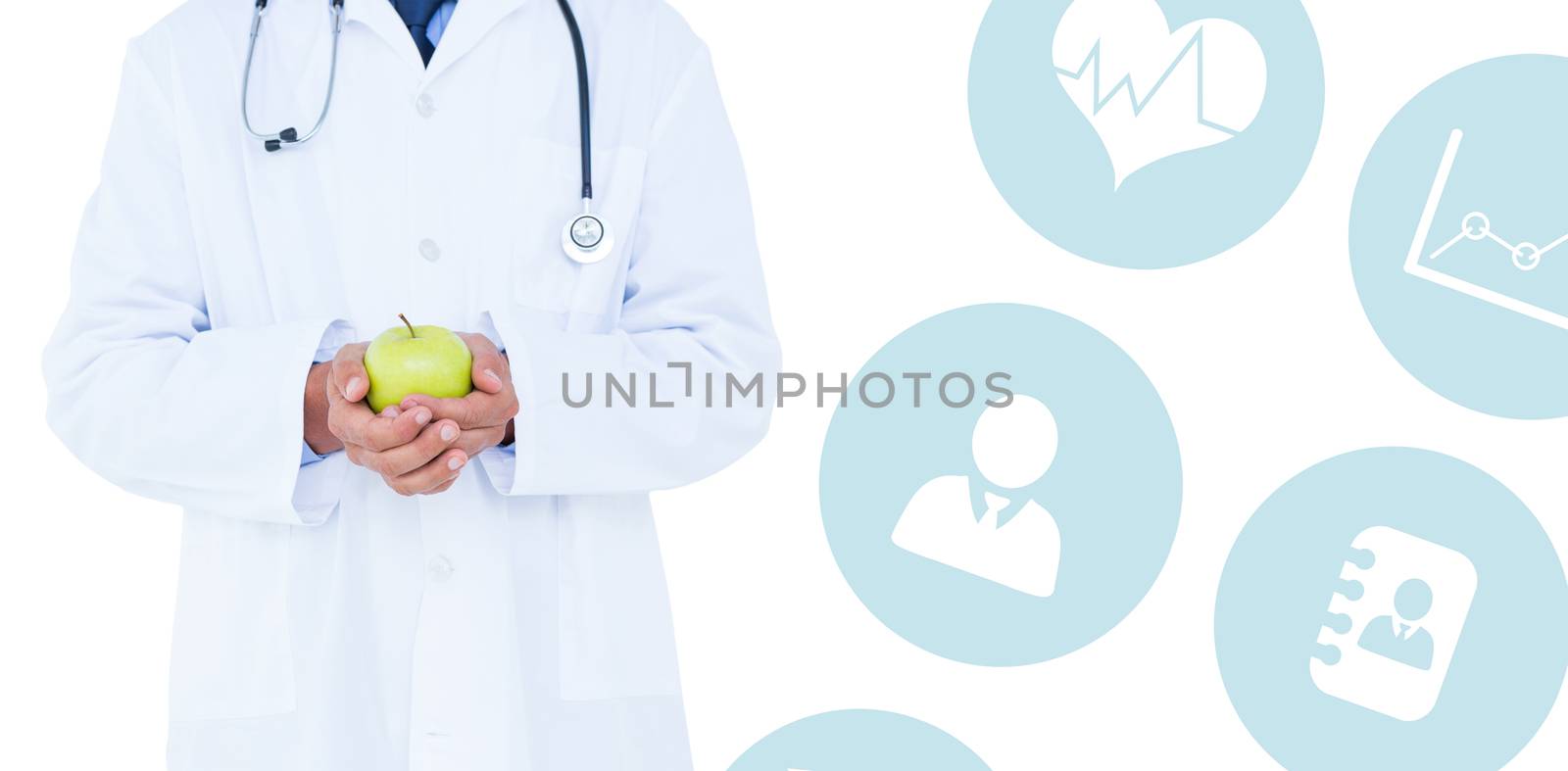 Male doctor holding green apple against medical app