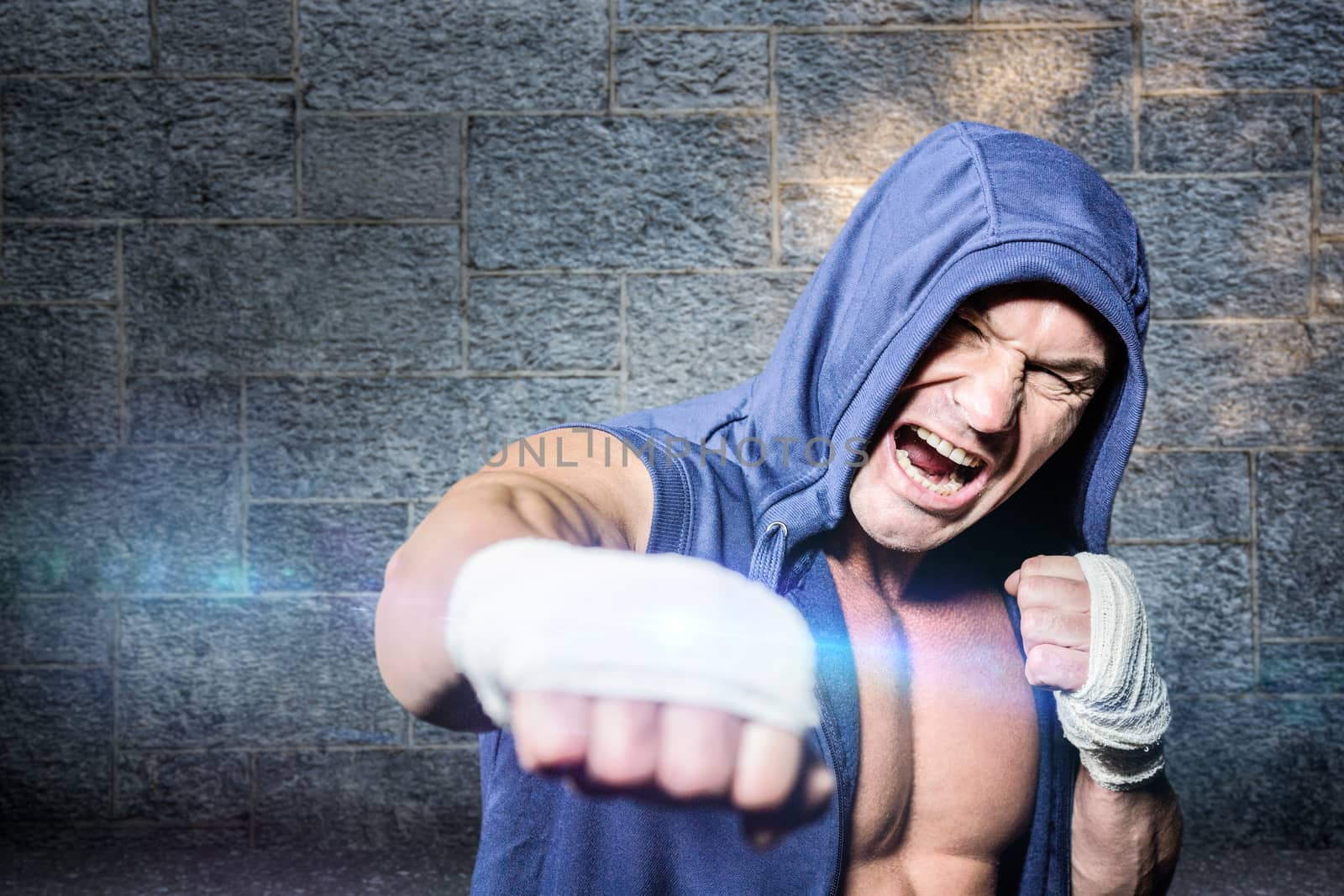 Composite image of aggressive fighter punching against black background by Wavebreakmedia