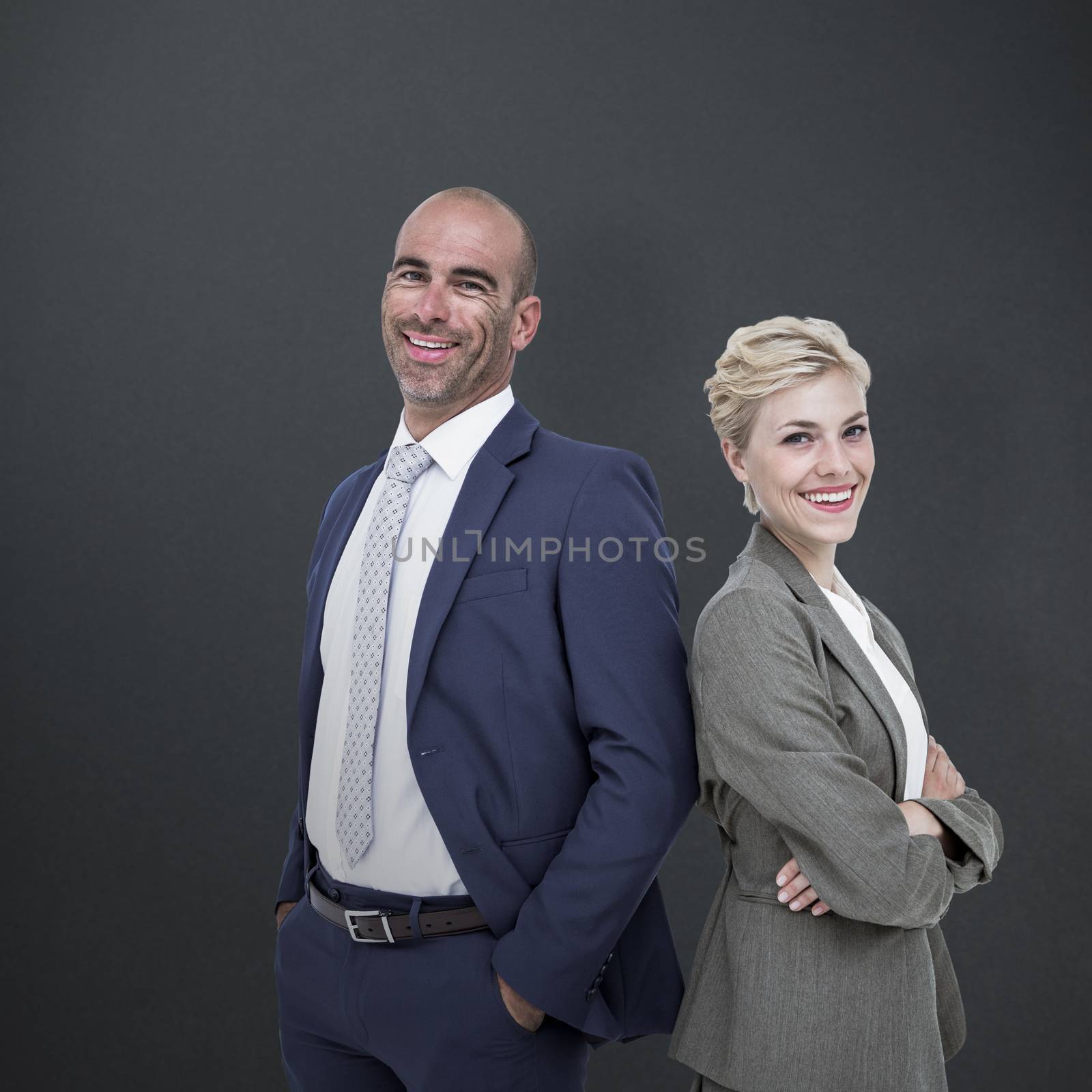  Smiling business people back-to-back against grey background