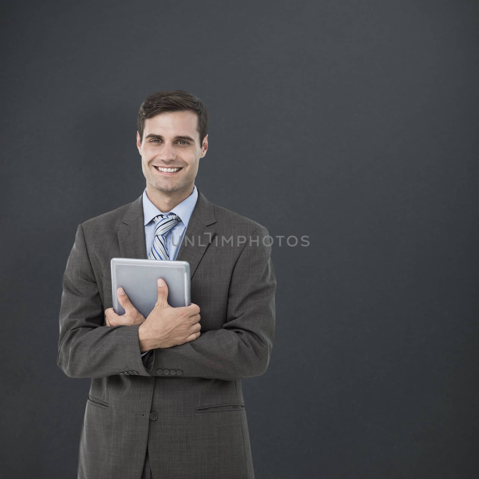Composite image of portrait of smiling businessman holding digital tablet by Wavebreakmedia