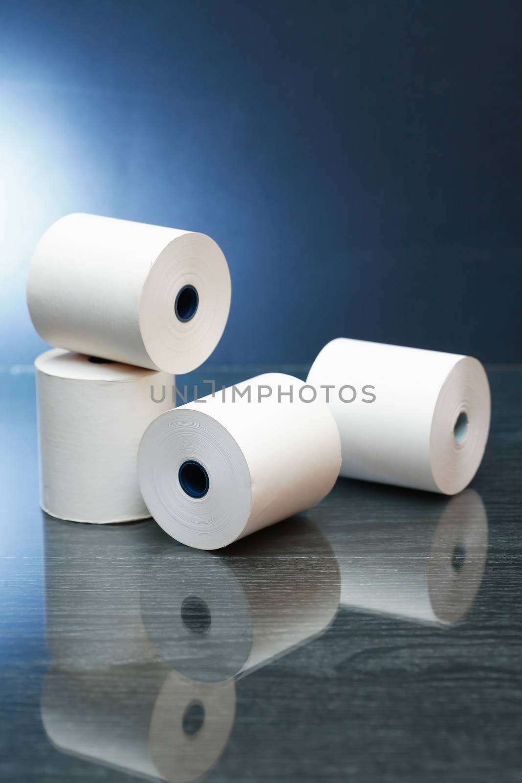 White paper rolls with reverberation on dark background