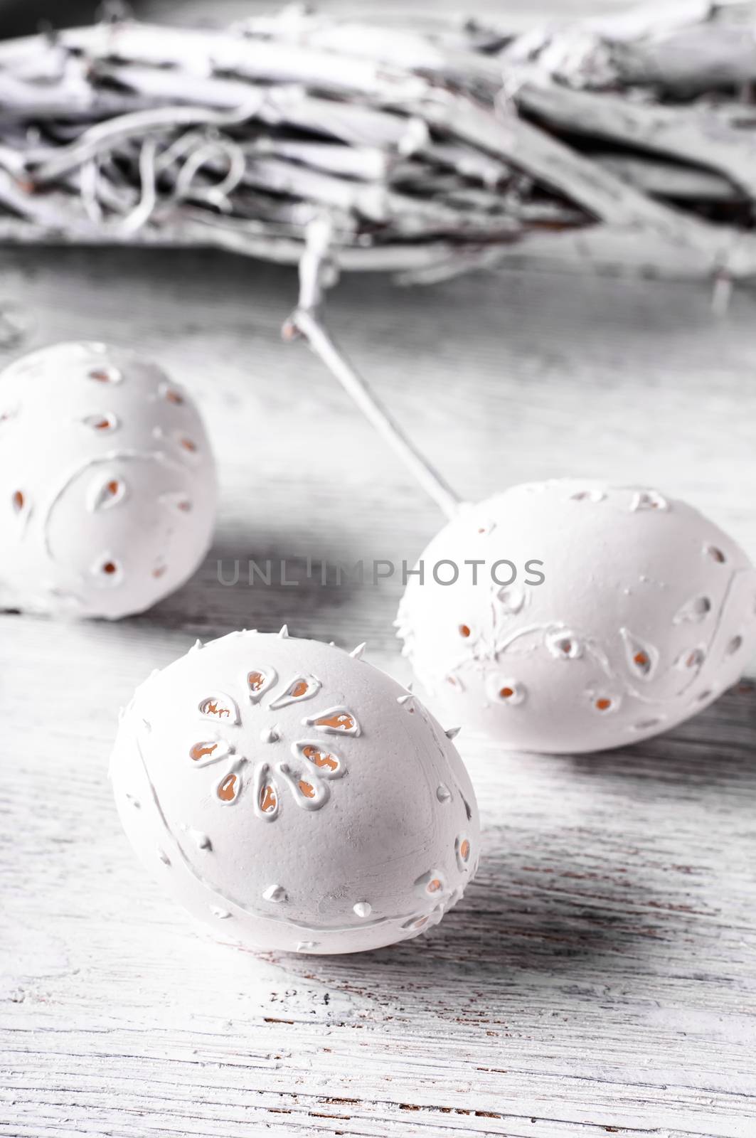 Easter eggs with cut out pattern by hand on light background.The photograph high key.