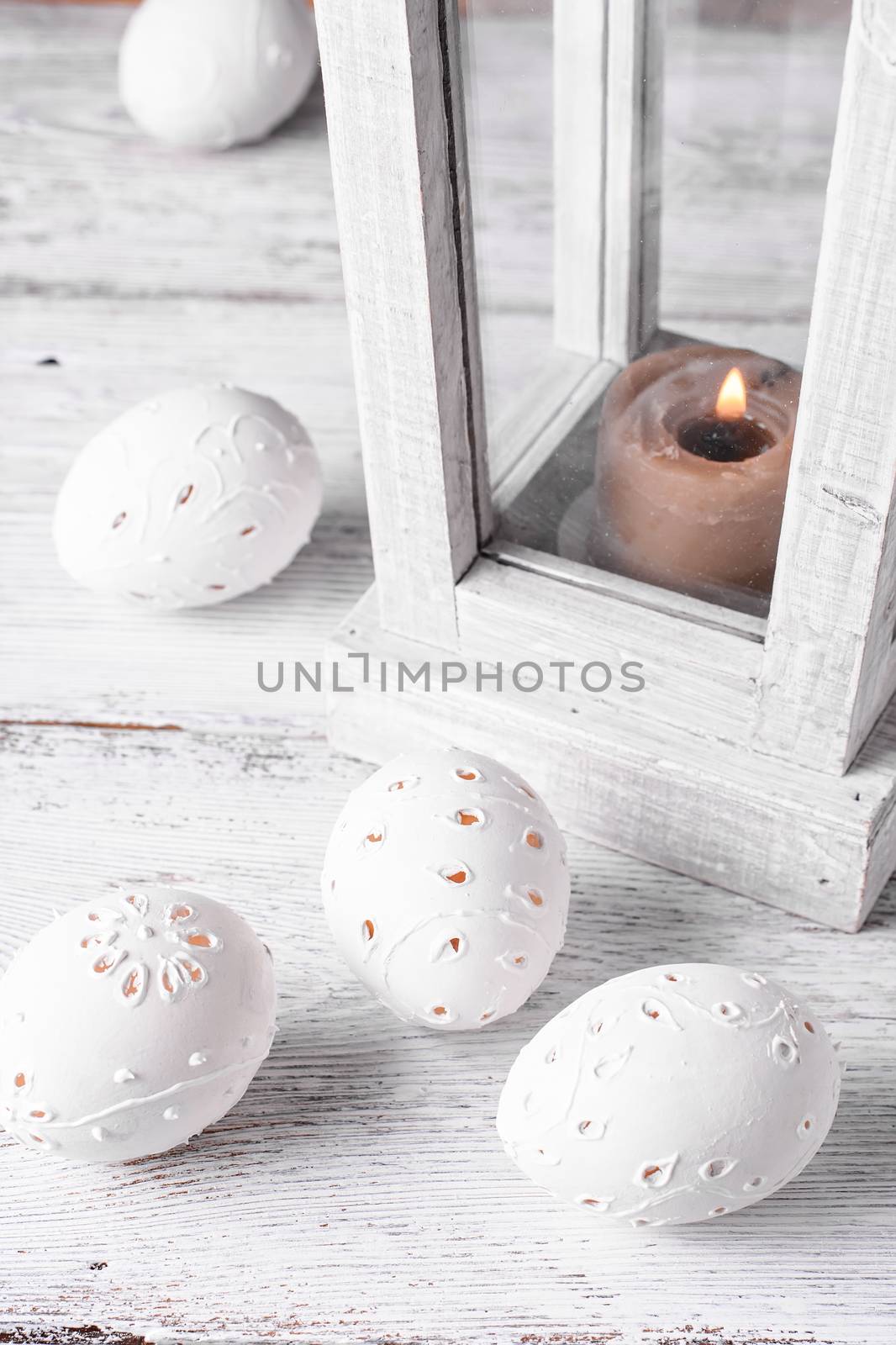 Easter eggs with cut out pattern by hand on light background.The photograph high key.