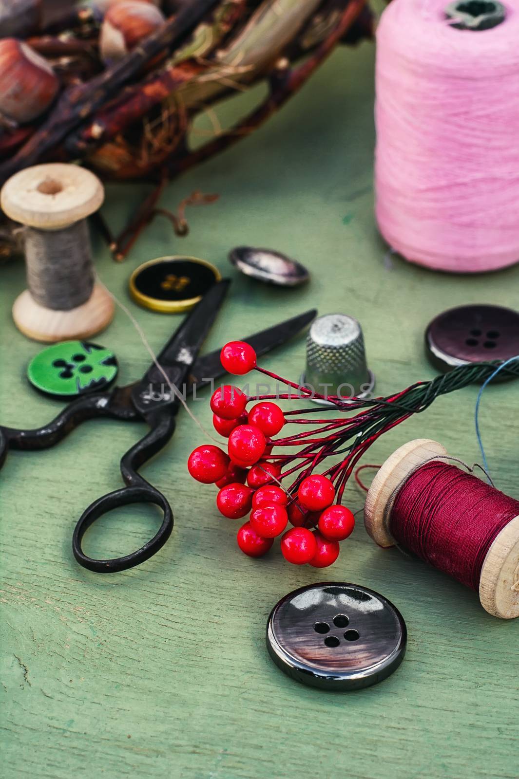 Thread for sewing,buttons and decoration on wooden background.