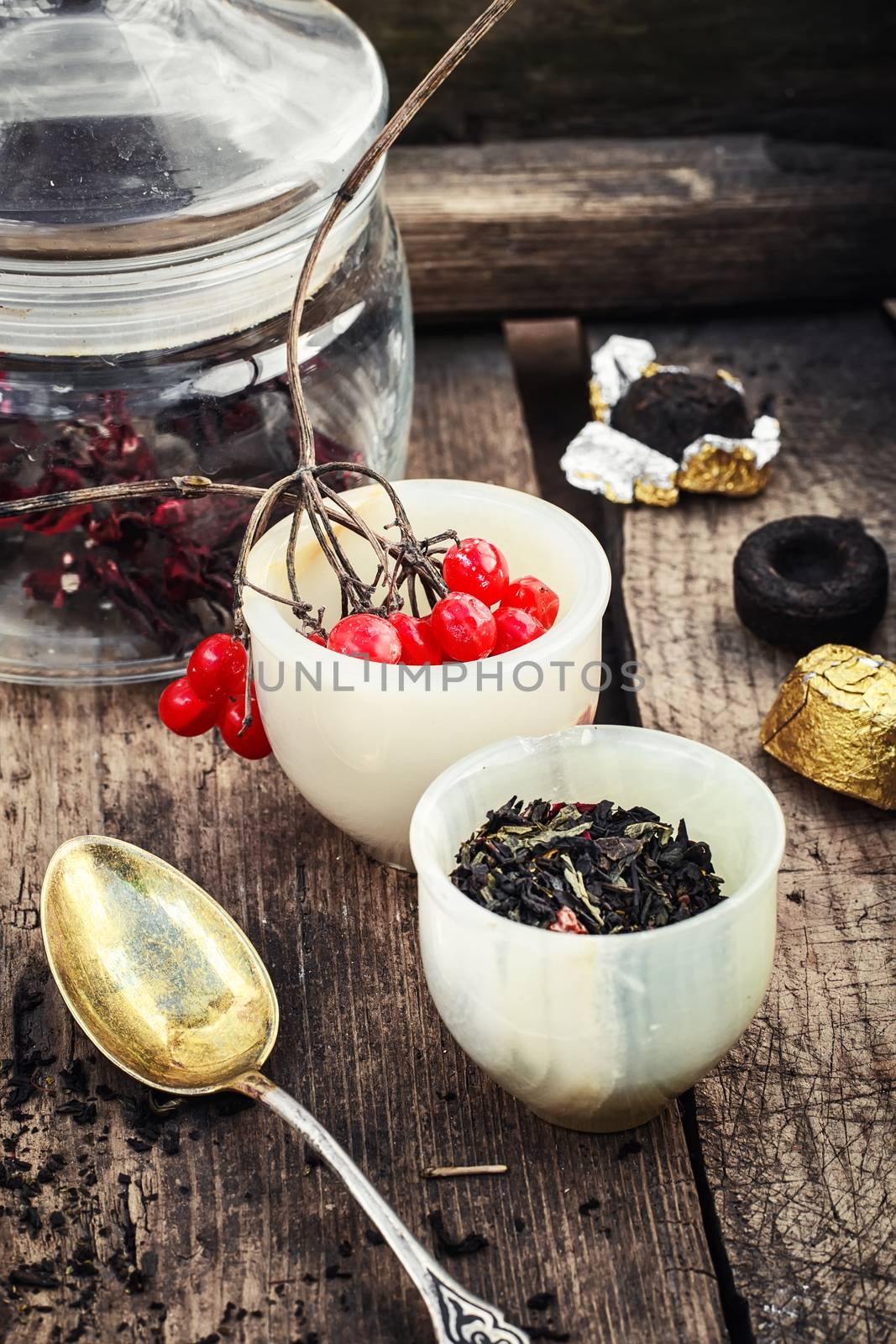 Tea leaves of different varieties in the stacks of custard and spoon