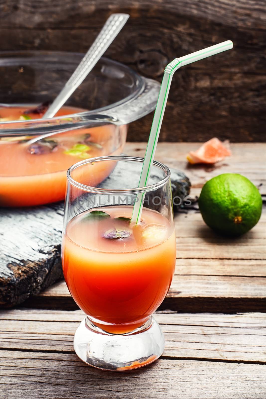 Glass of fresh juice from orange and lime.