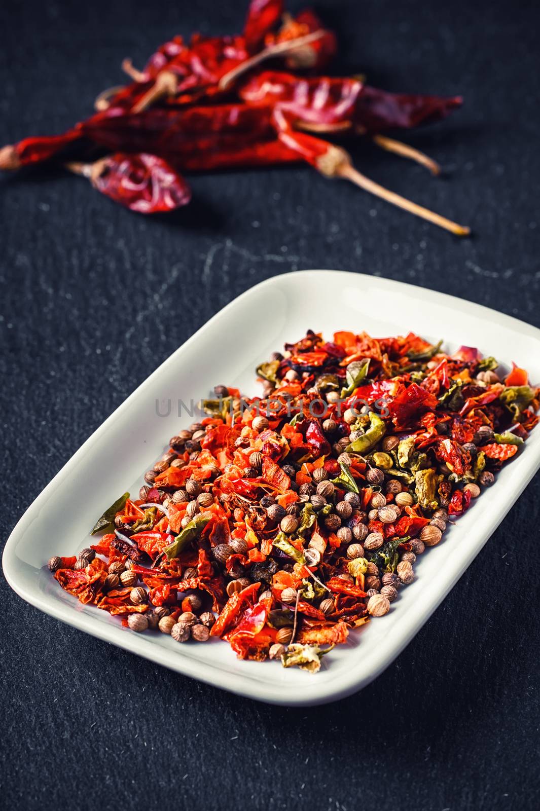 Assembly seasoning of pepper and hot spices in a porcelain bowl