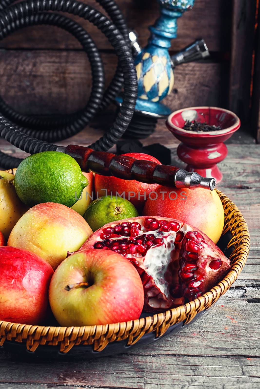 Stylish Smoking hookah and basket with apples,pomegranate and lime