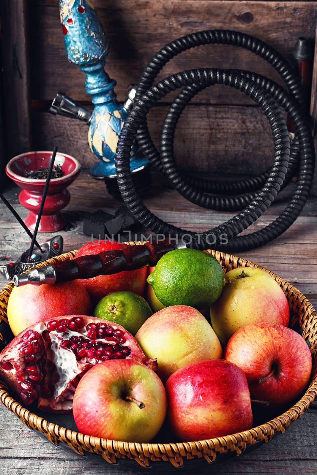 Stylish Smoking hookah and basket with apples,pomegranate and lime