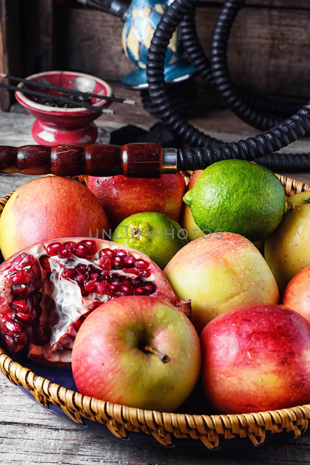 Stylish Smoking hookah and basket with apples,pomegranate and lime