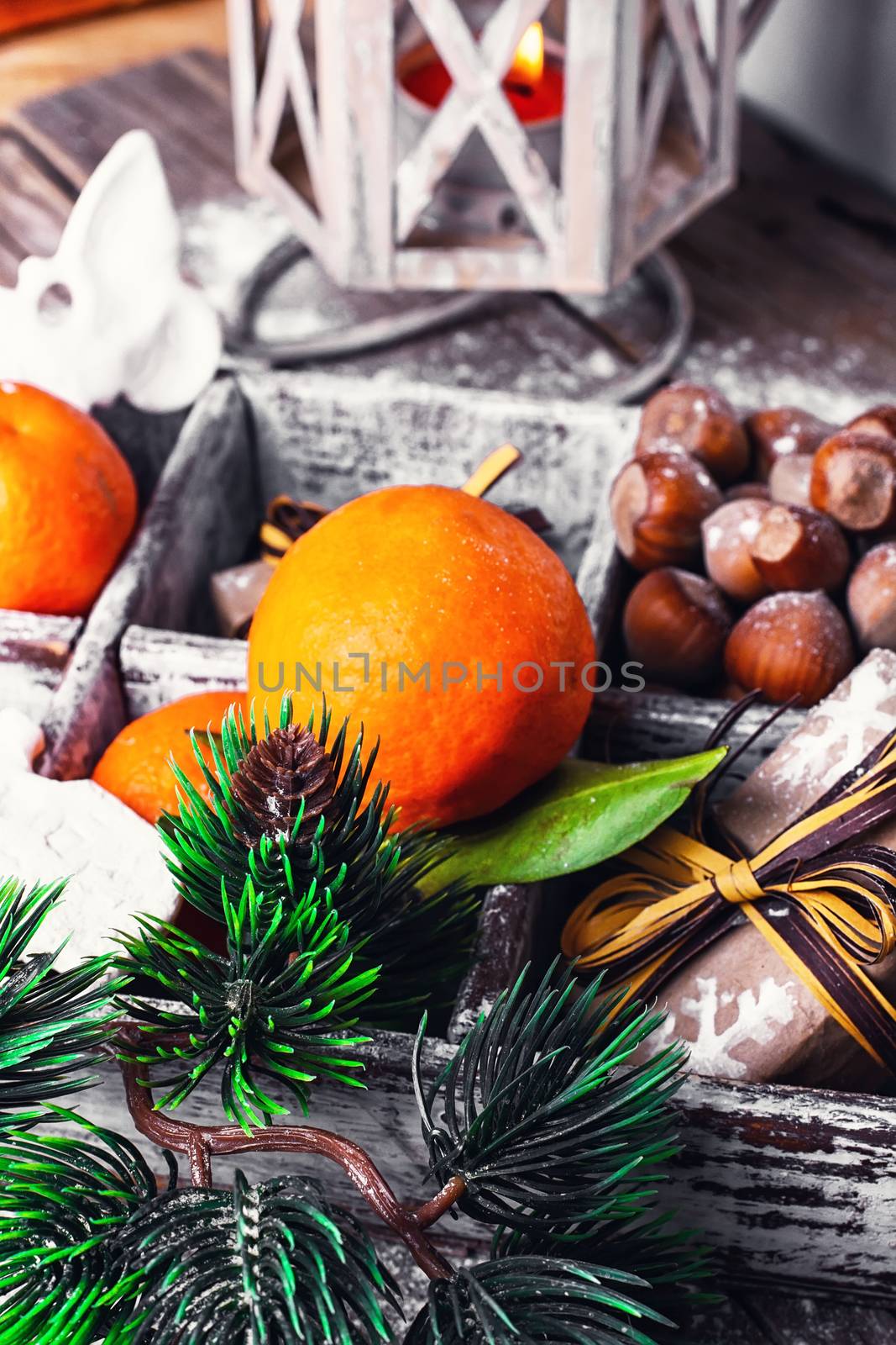 Decorative wooden box with hazelnuts,mandarins and gifts.