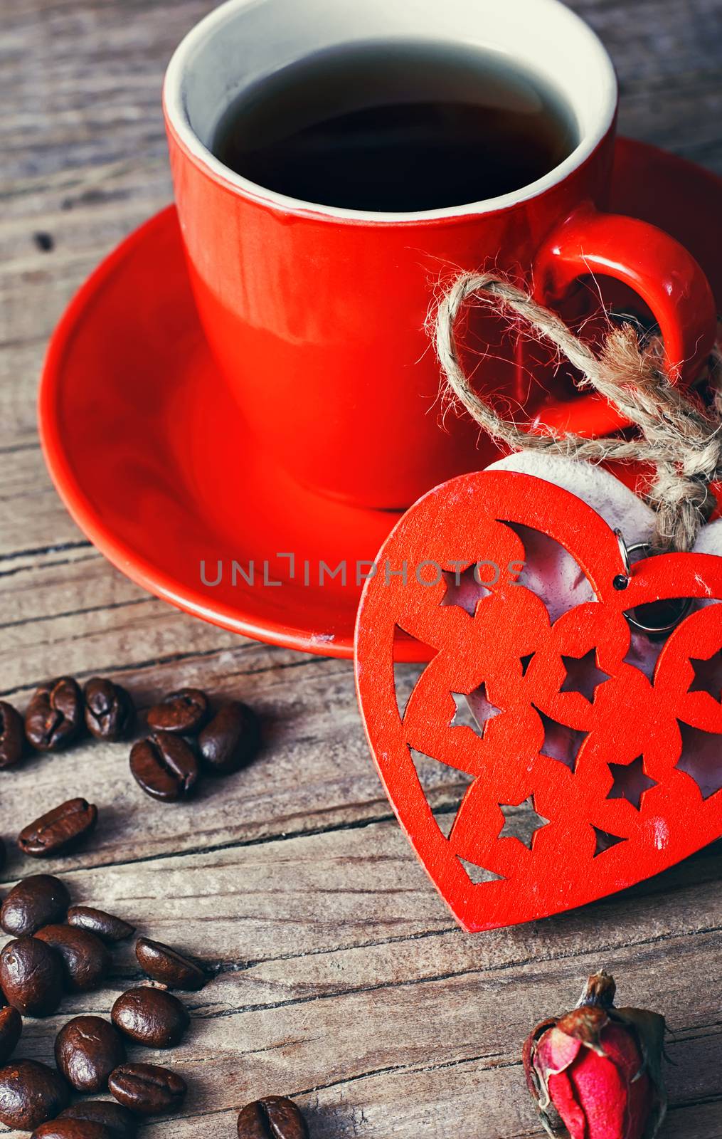 Coffee mug with tied wooden hearts for Valentine's day.Selective focus