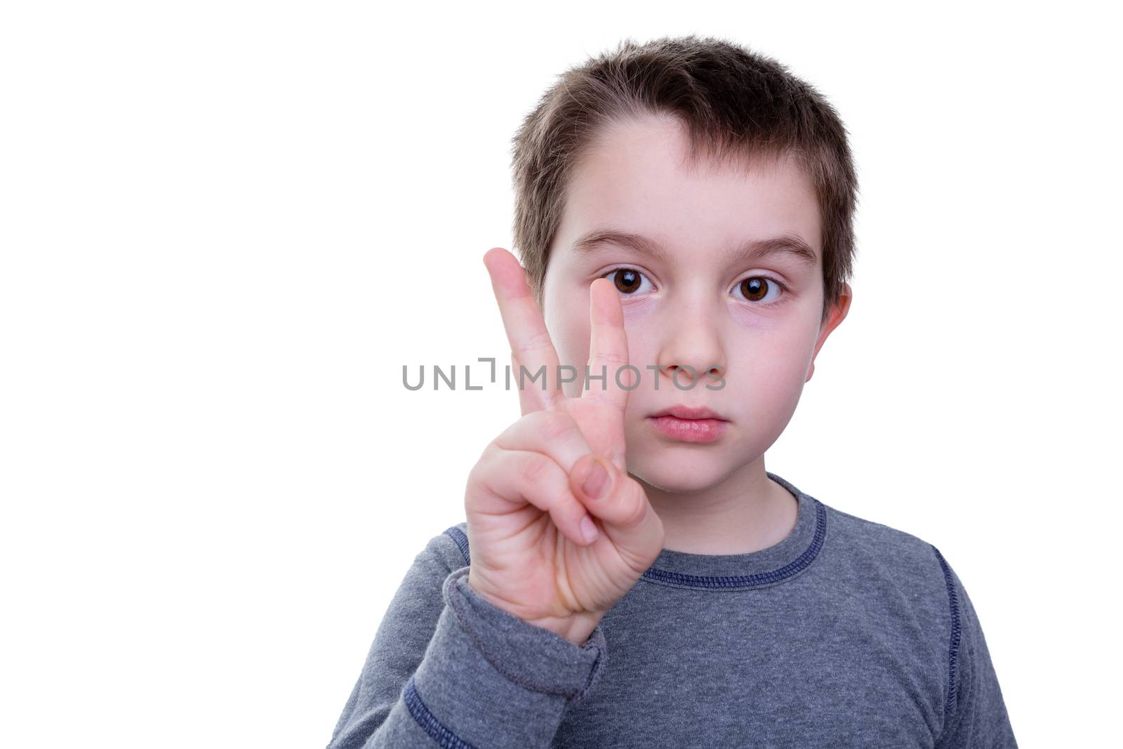 Close up of serious little boy gesturing with two fingers as if to count or display a sign language letter