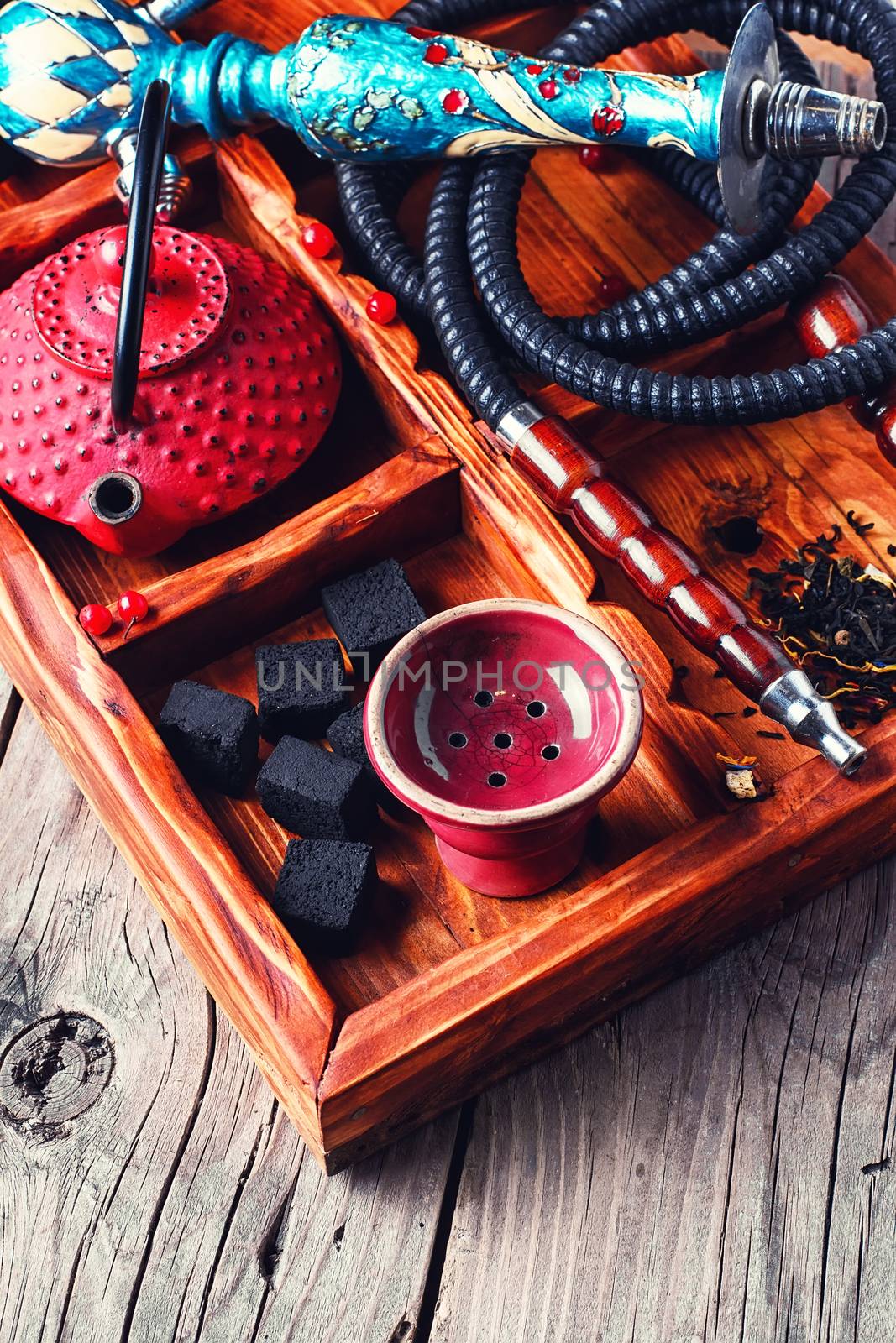 Details of smoking hookah,cast iron red teapot in wooden box