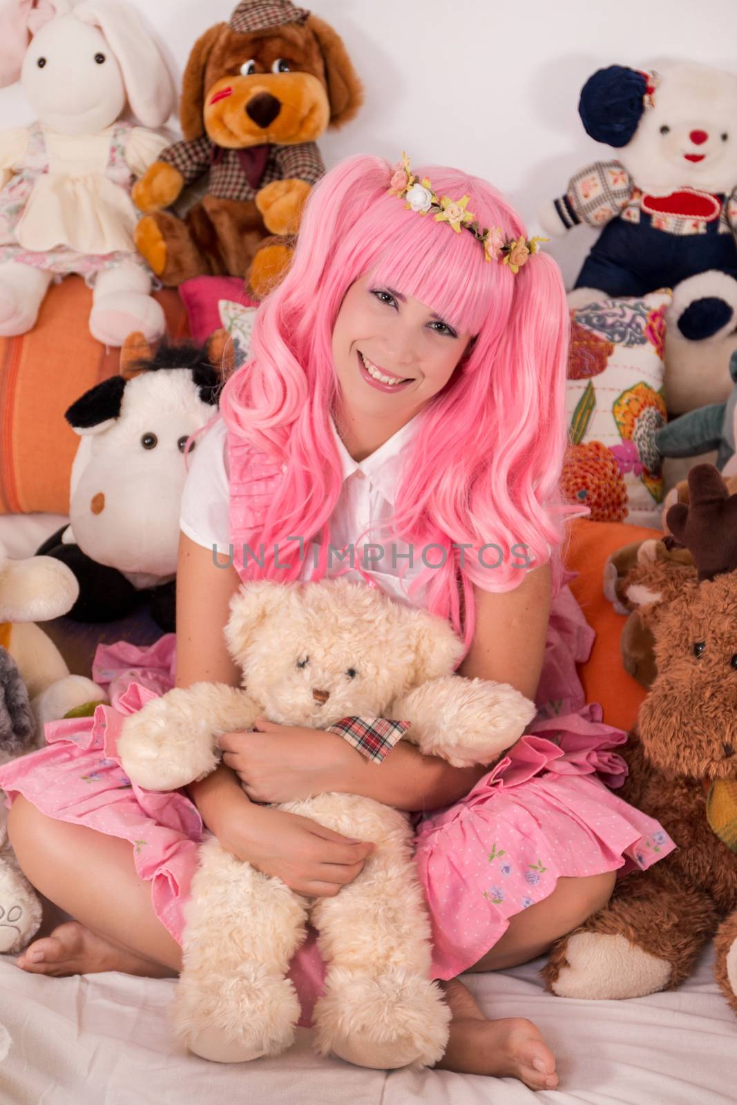 young girl in a bedroom in a pink cute dress