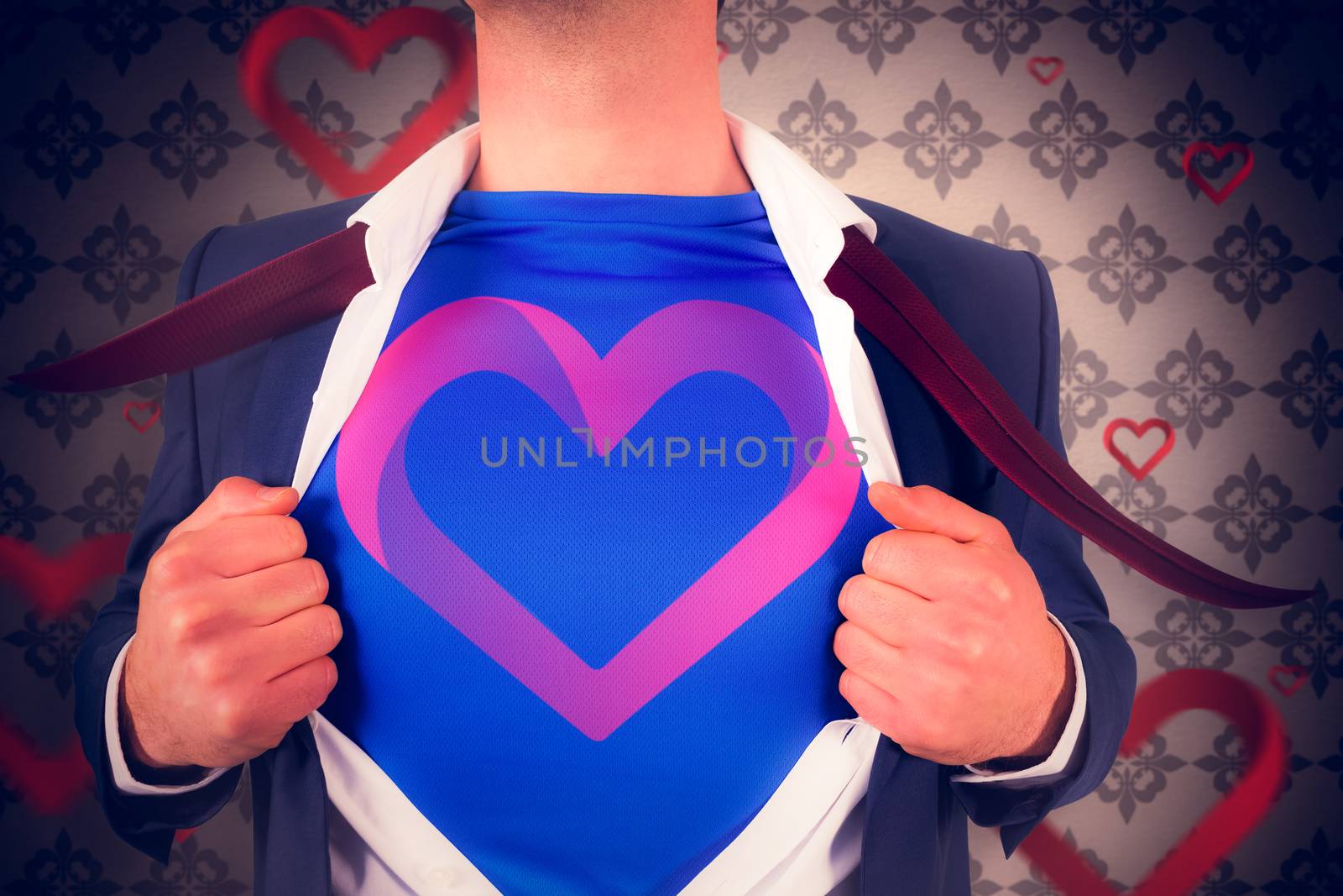 Businessman opening his shirt superhero style against love heart pattern