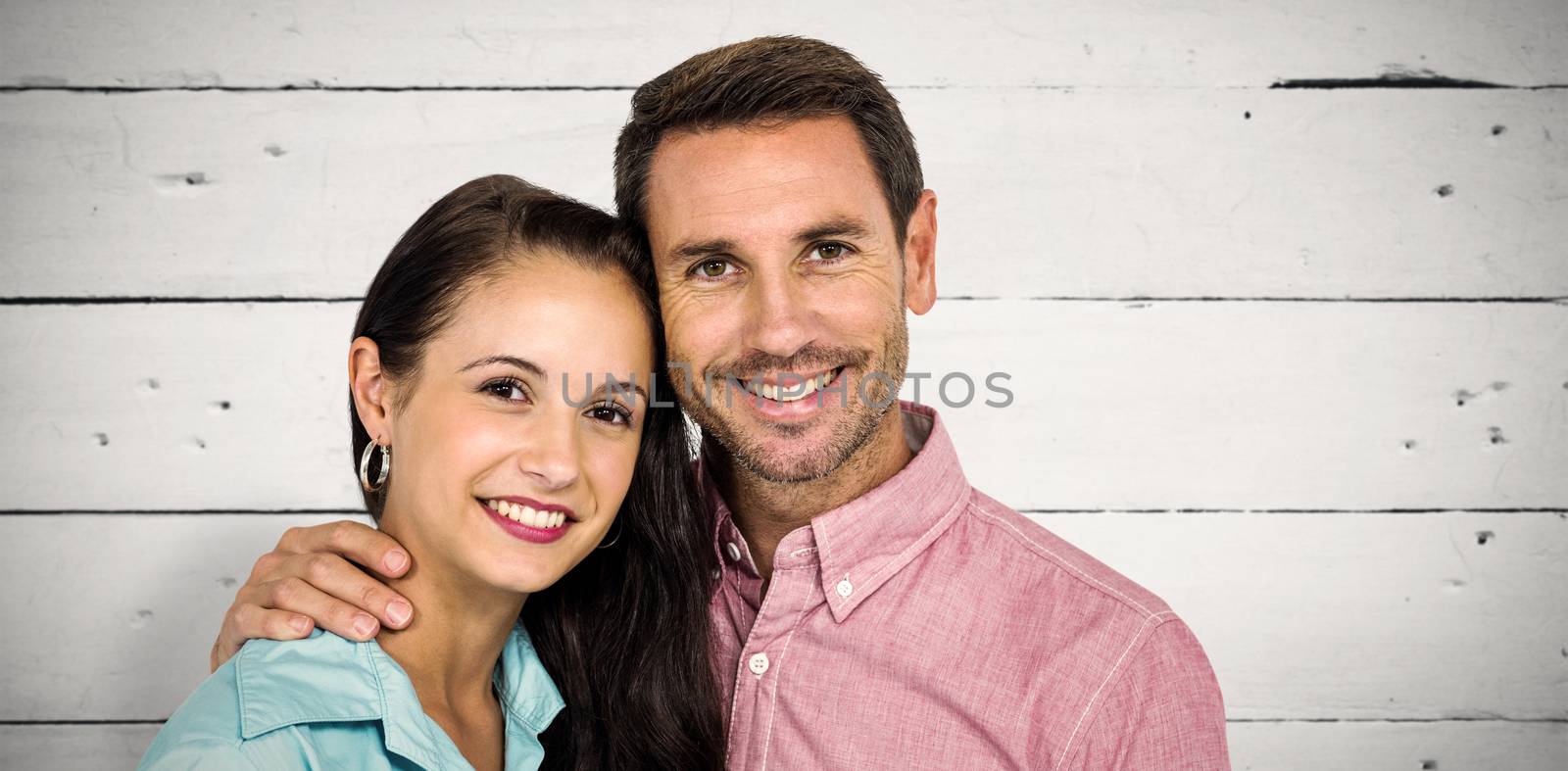 Composite image of smiling couple looking at camera by Wavebreakmedia