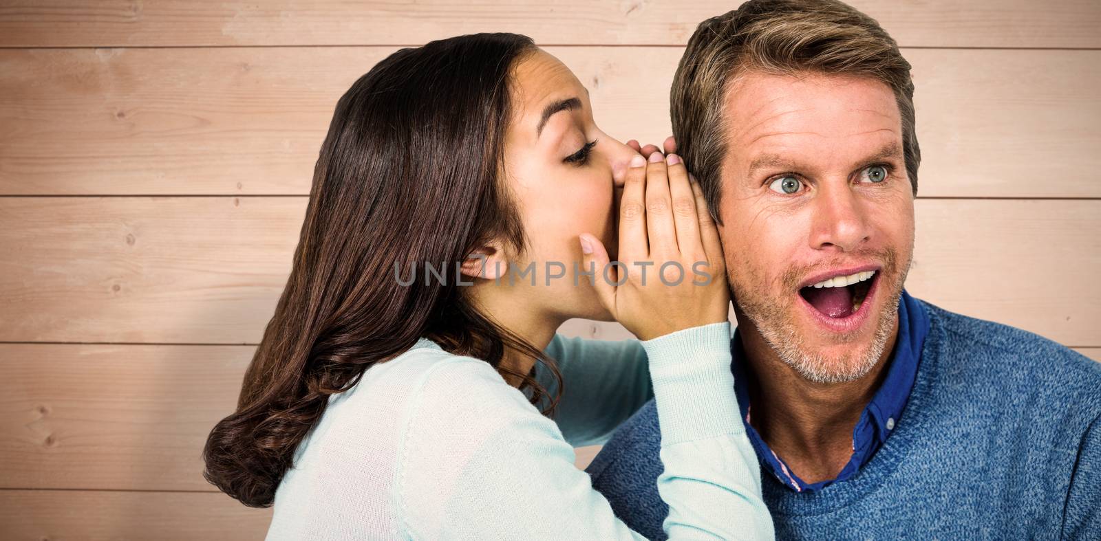 Composite image of woman whispering secret with man by Wavebreakmedia