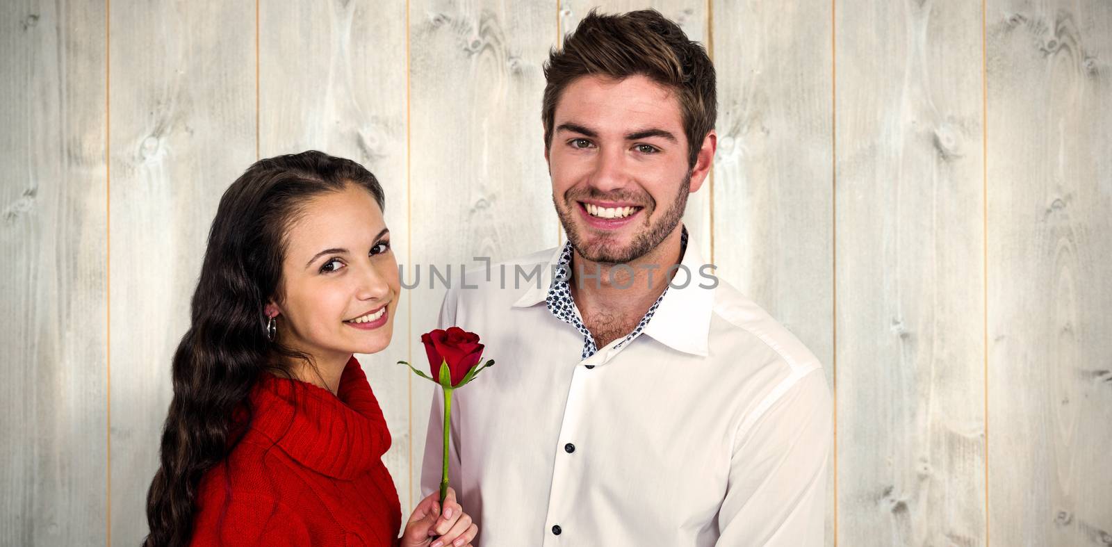 Composite image of smiling couple with rose by Wavebreakmedia
