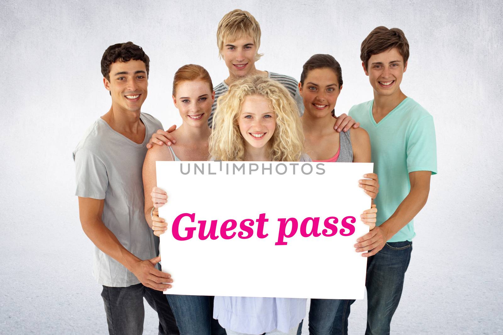 The word guest pass and group of teenagers holding a blank card against white wall