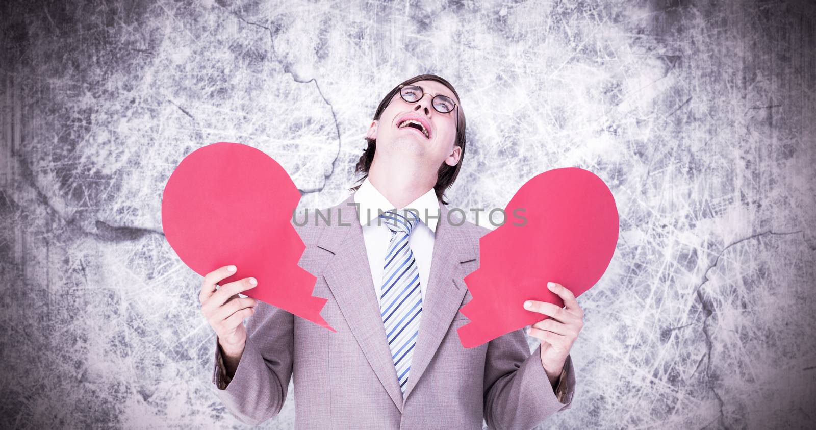 Composite image of geeky businessman crying and holding broken heart card by Wavebreakmedia