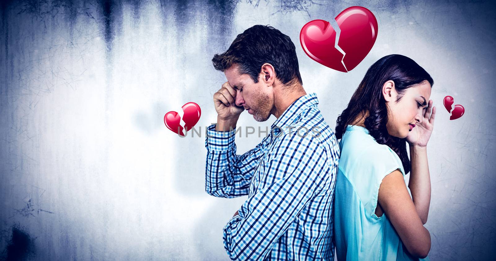 Composite image of depressed couple standing back to back by Wavebreakmedia