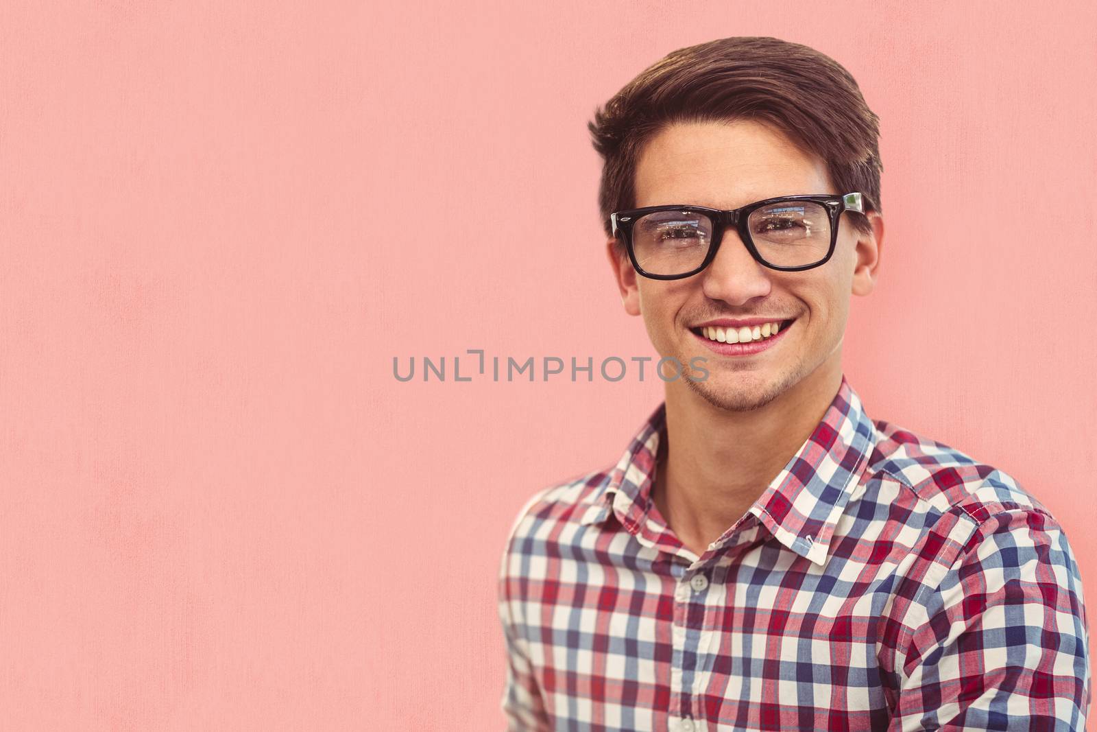 Young businessman smiling against white background