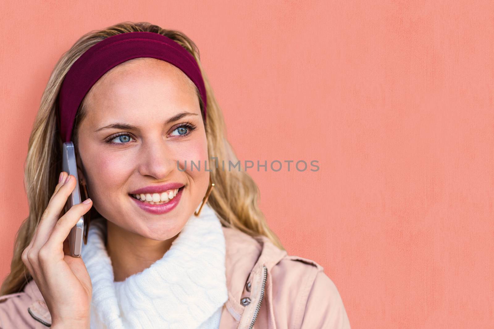 Smiling woman phoning with smartphone against white background