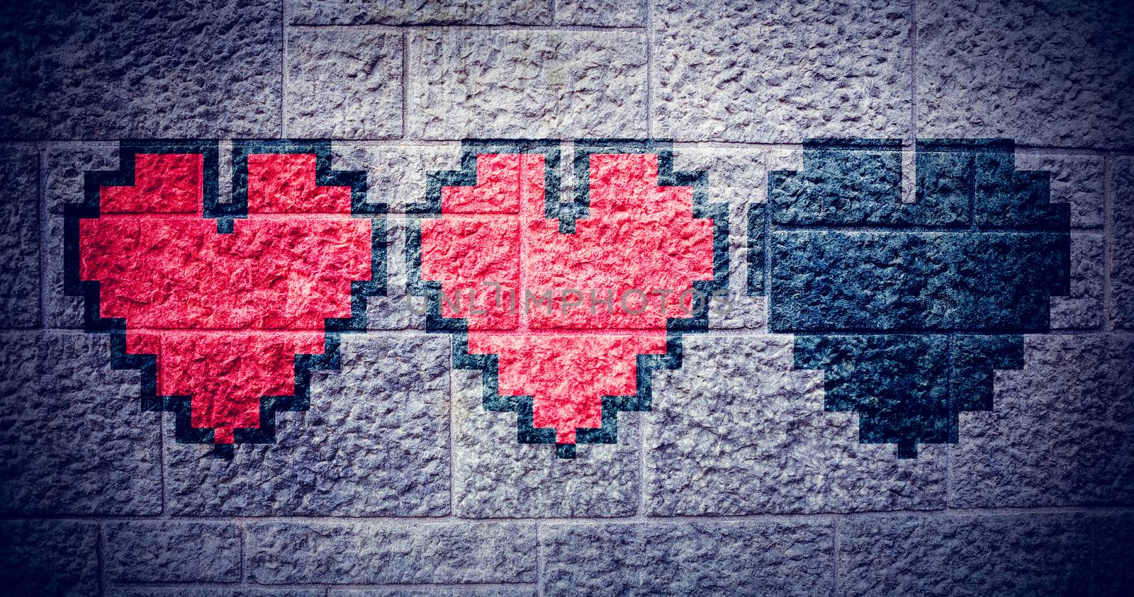 heart against grey brick wall