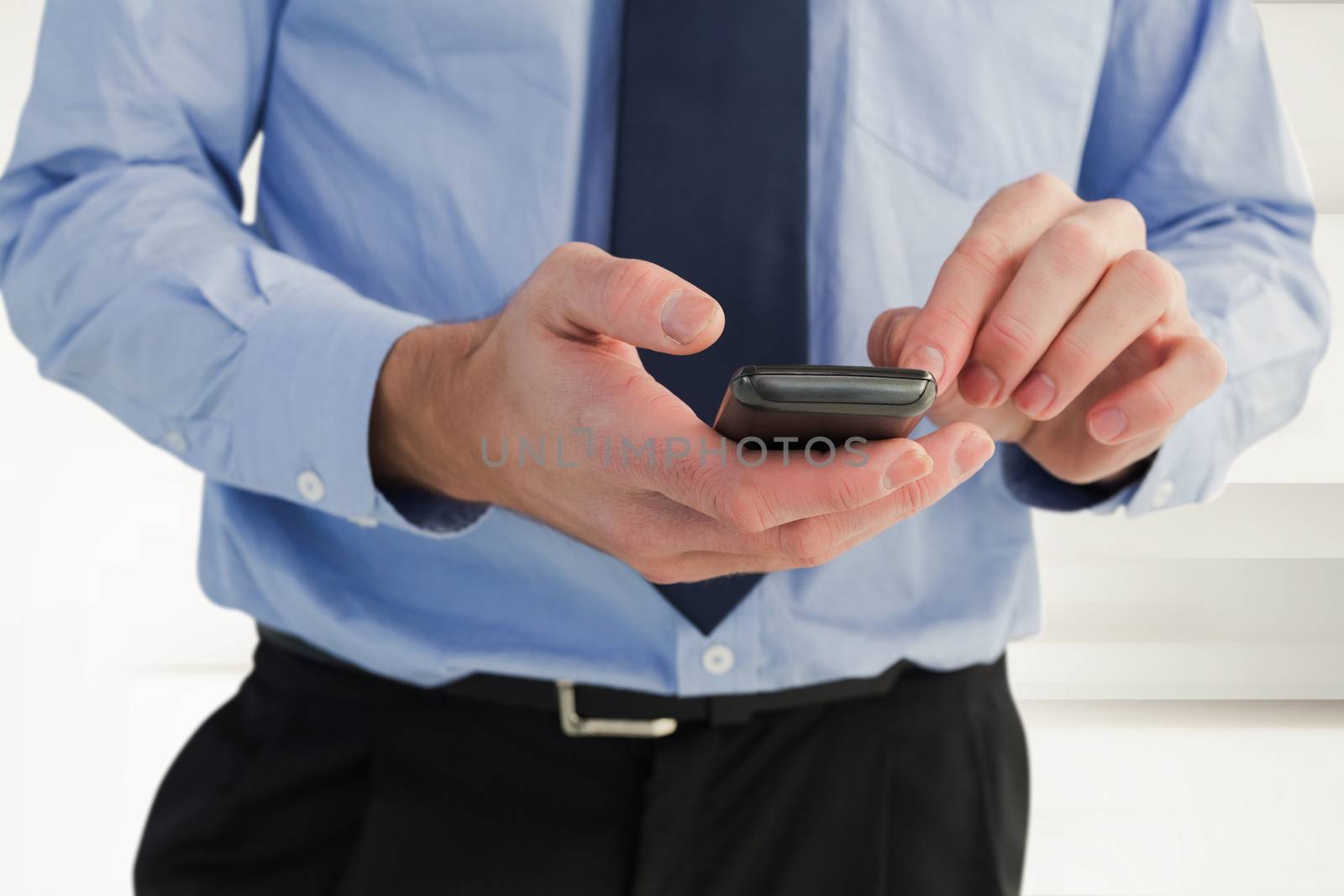 Close up of a businessman using a smartphone against abstract white design