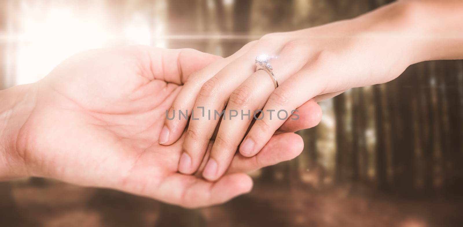 Close-up of couple holding hands against autumn scene