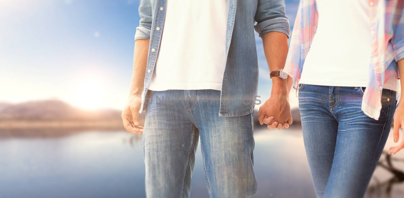 Composite image of hip young couple holding hands by Wavebreakmedia