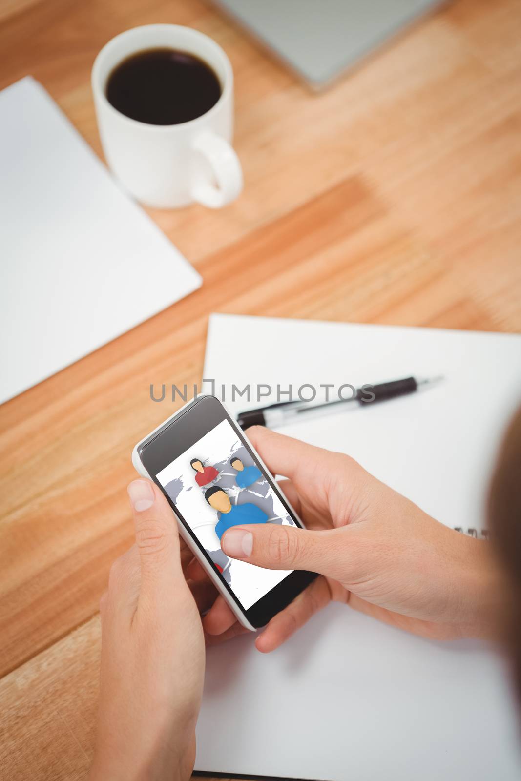 Composite image of businessman using smartphone at desk in office by Wavebreakmedia