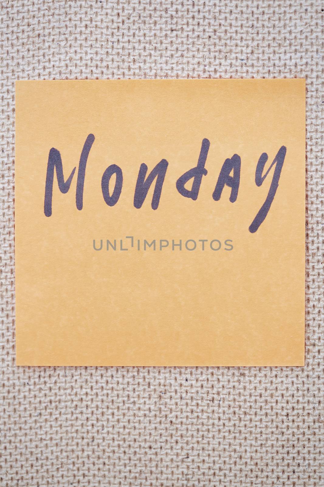 Adhesive note with Monday text on a bulletin board