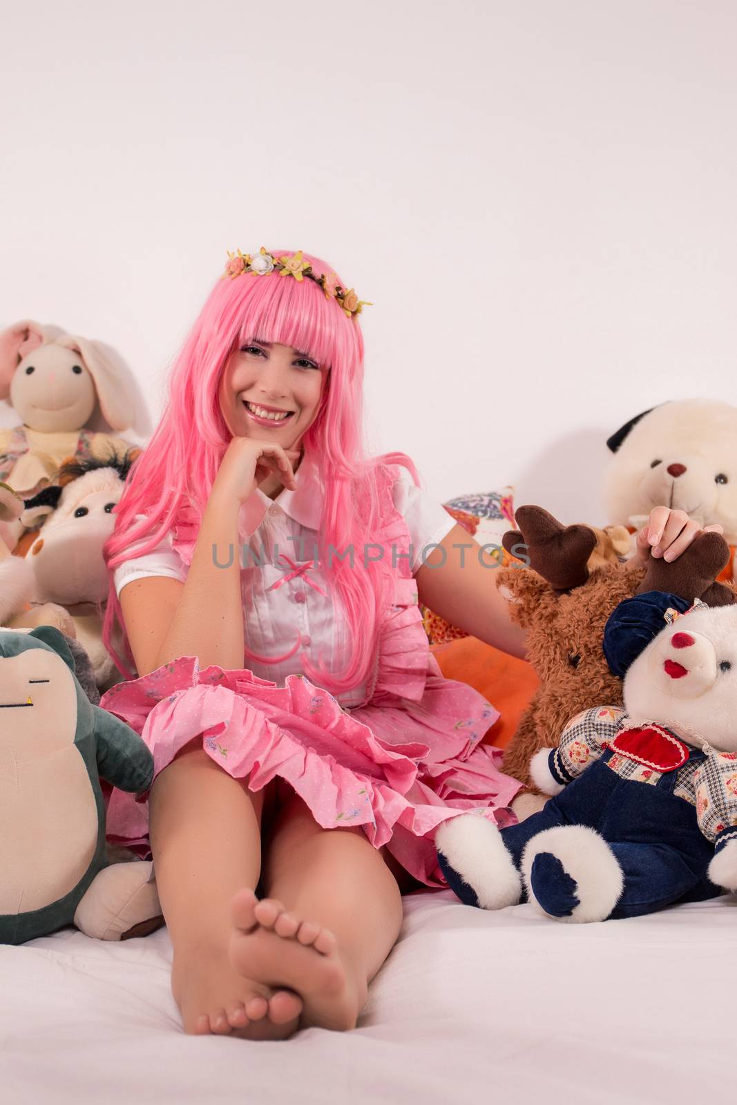 young girl in a bedroom in a pink cute dress