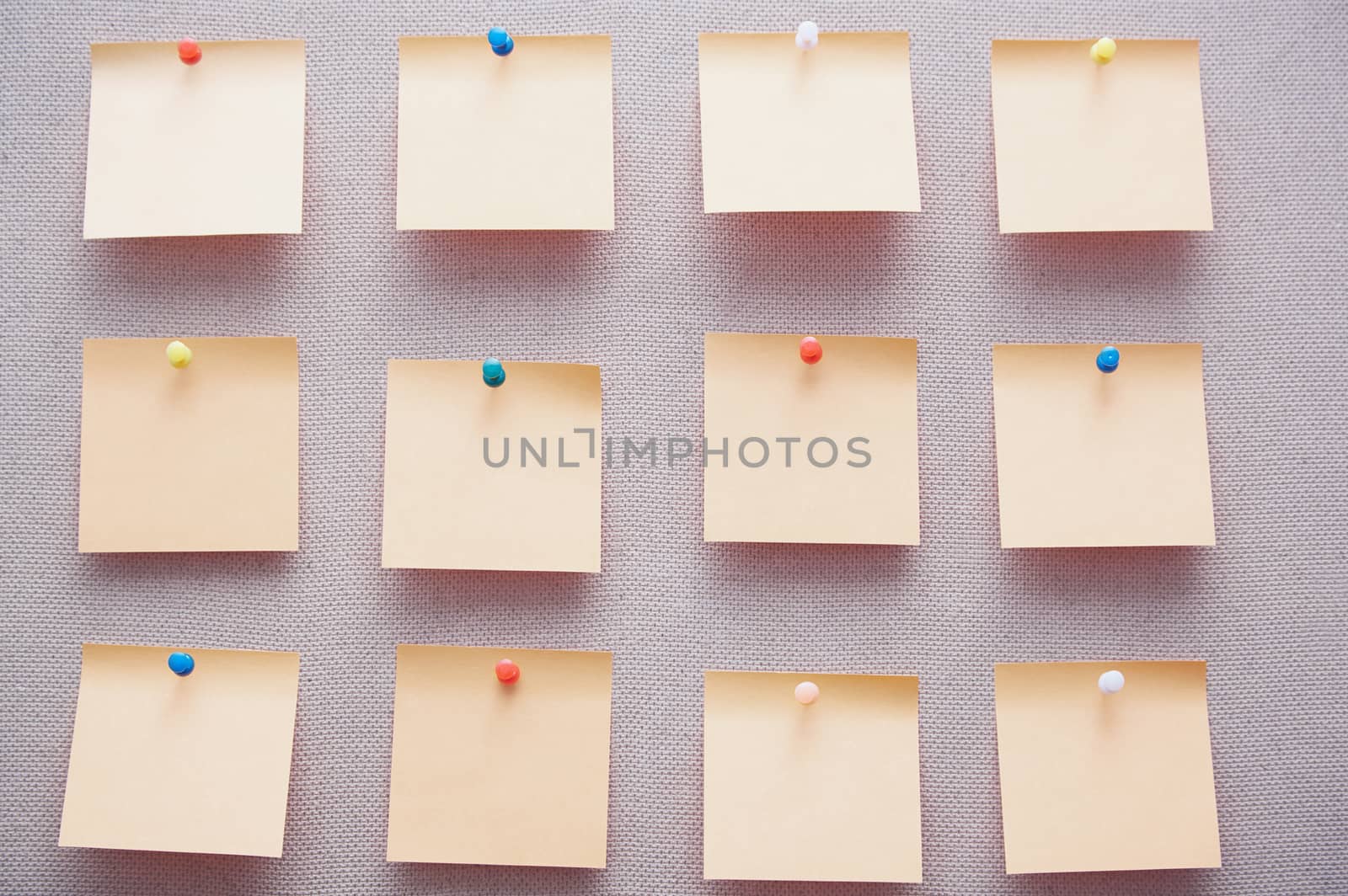 Sticky notes on a bulletin board. Close-up view