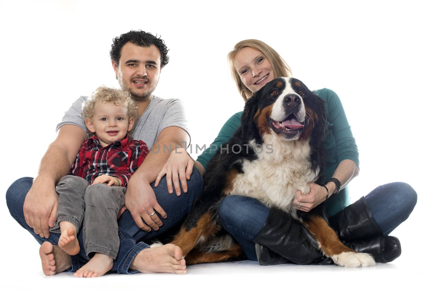 family and dog in front of white background